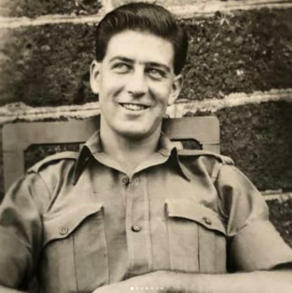 Old photo of a handsome man in army gears leaning against seat