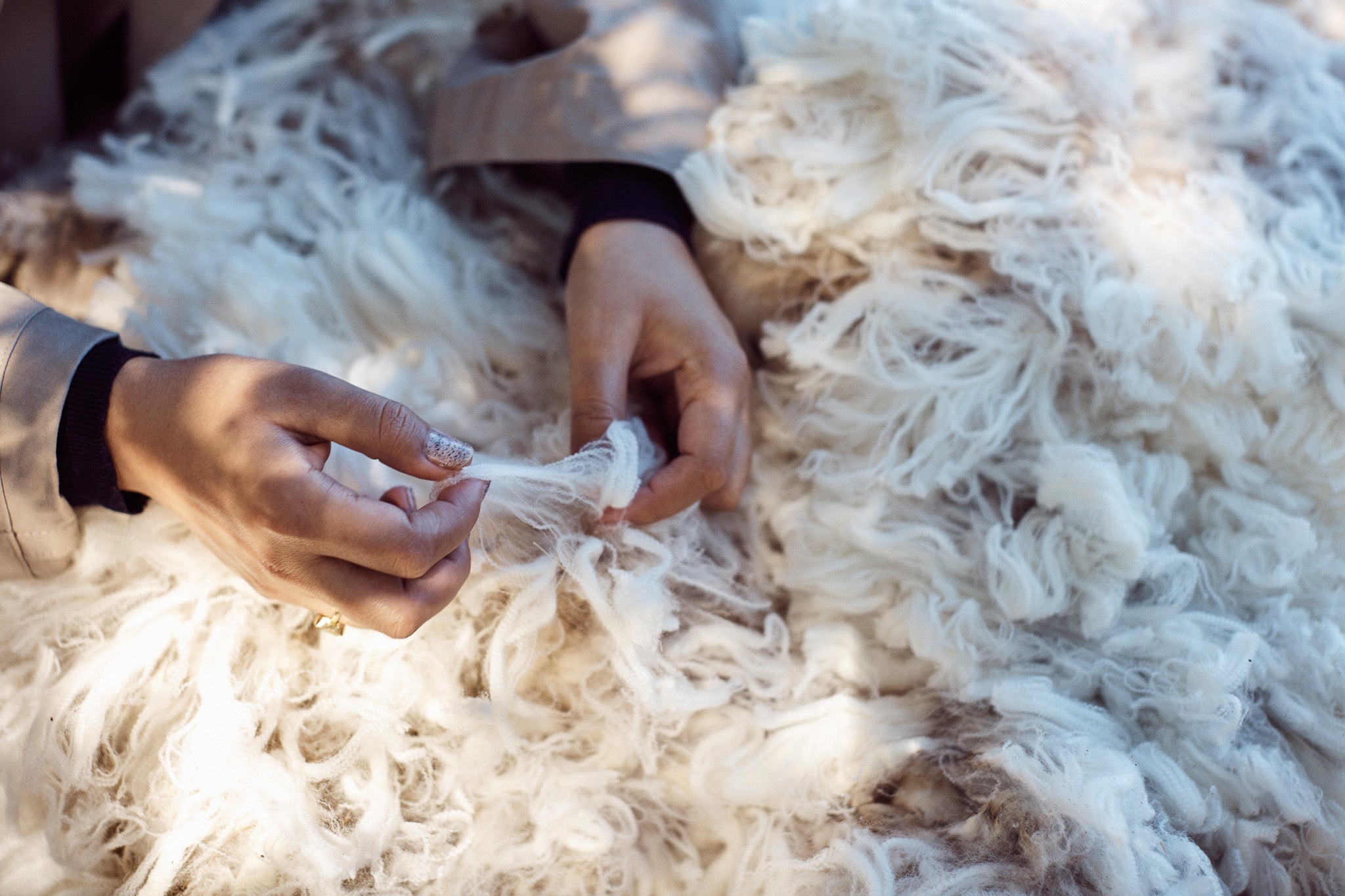 Woman pulling Woolmark certified merino wool recently shared.