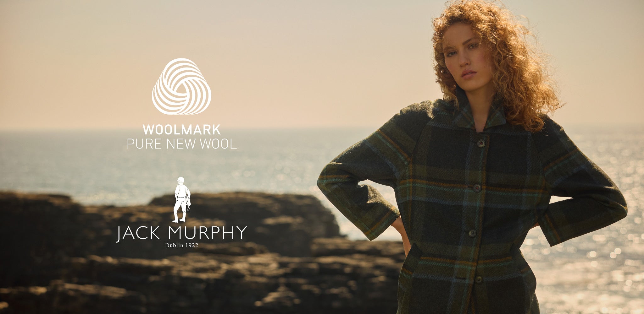 Woman wearing Woolmark-certified Jack Murphy tweed coat in sage & emerald check