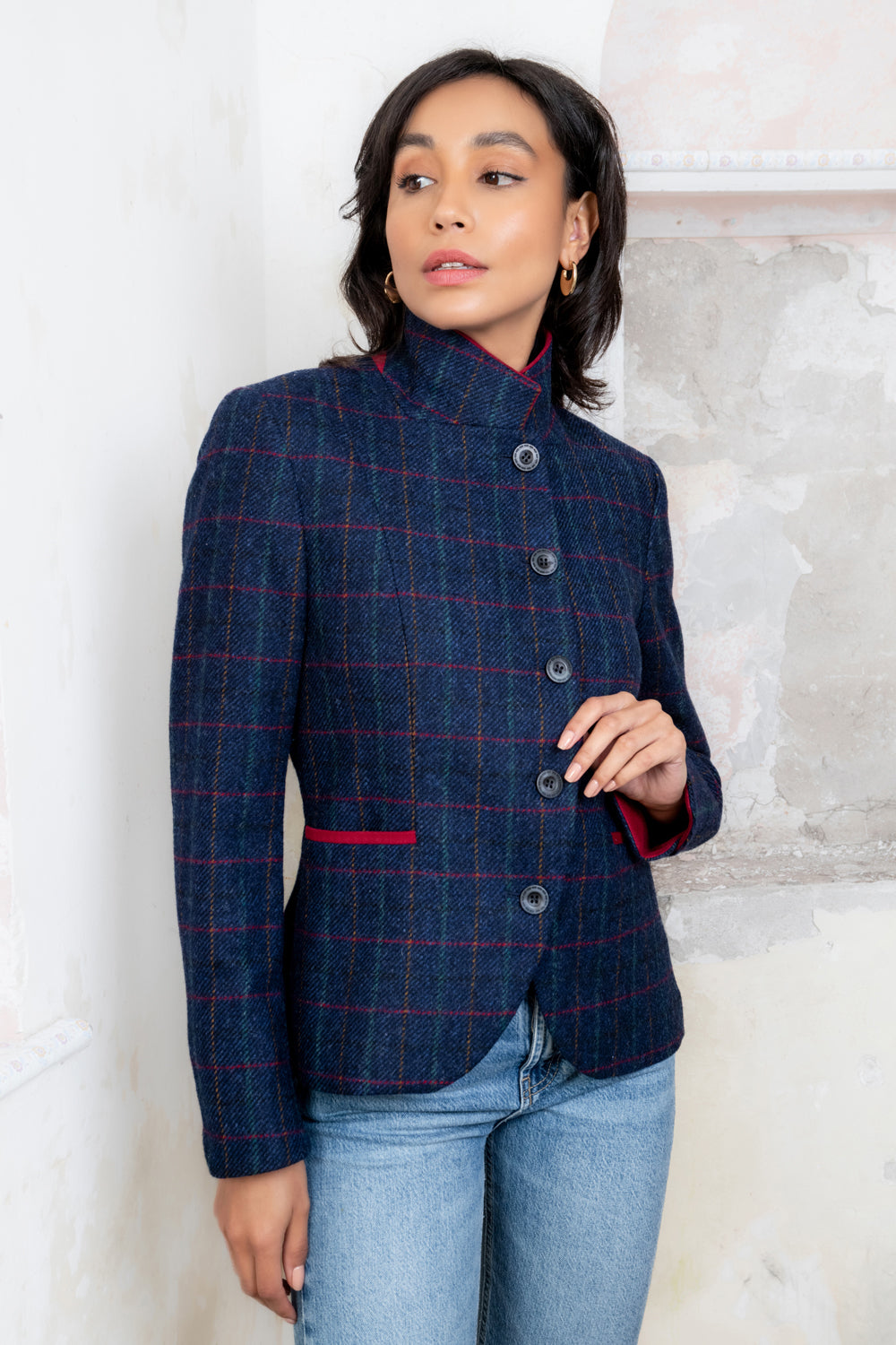 Dark haired. woman in Navy tweed jacket.