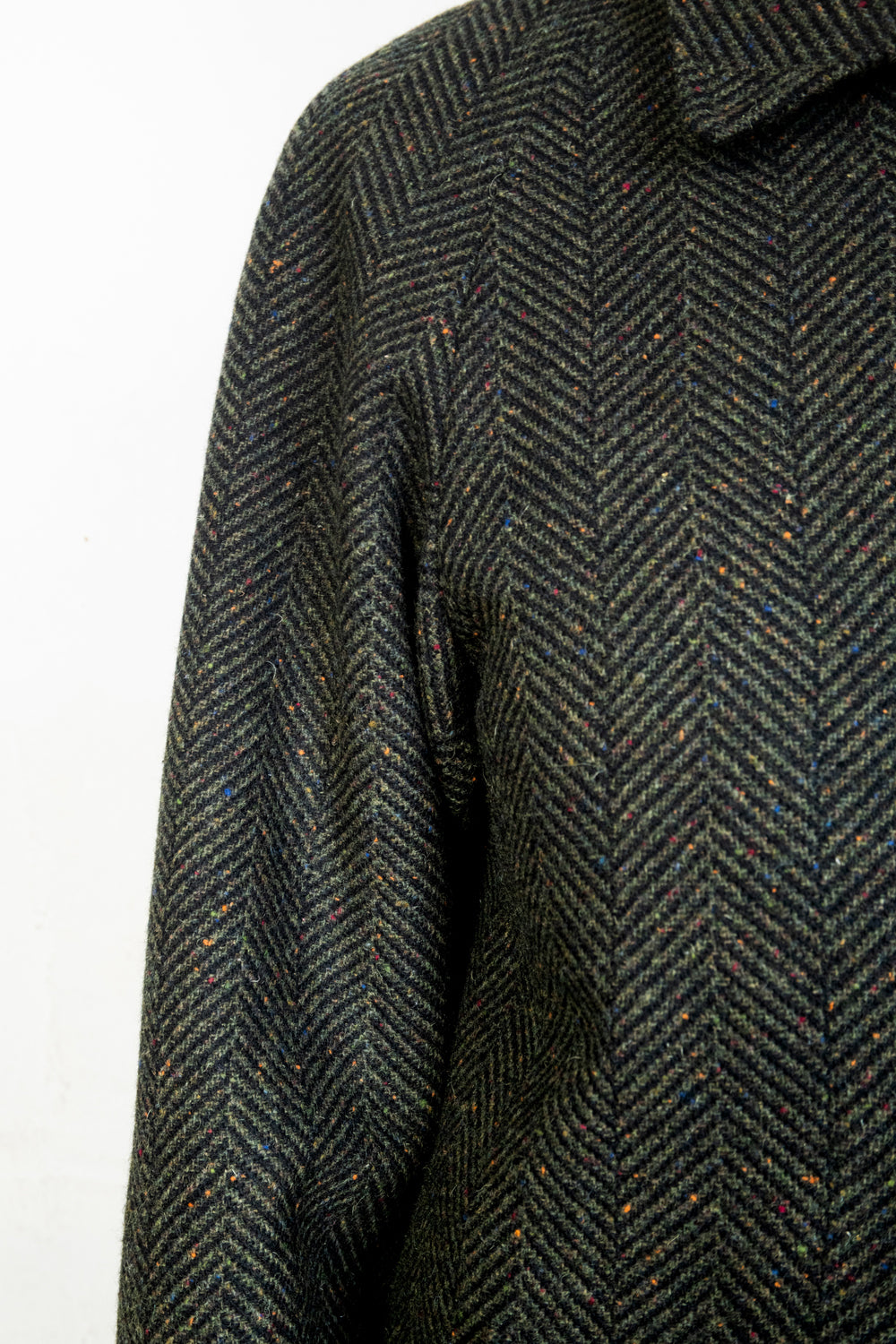 Green Fleck Tweed fabric close up with hints of blue, green, orange,